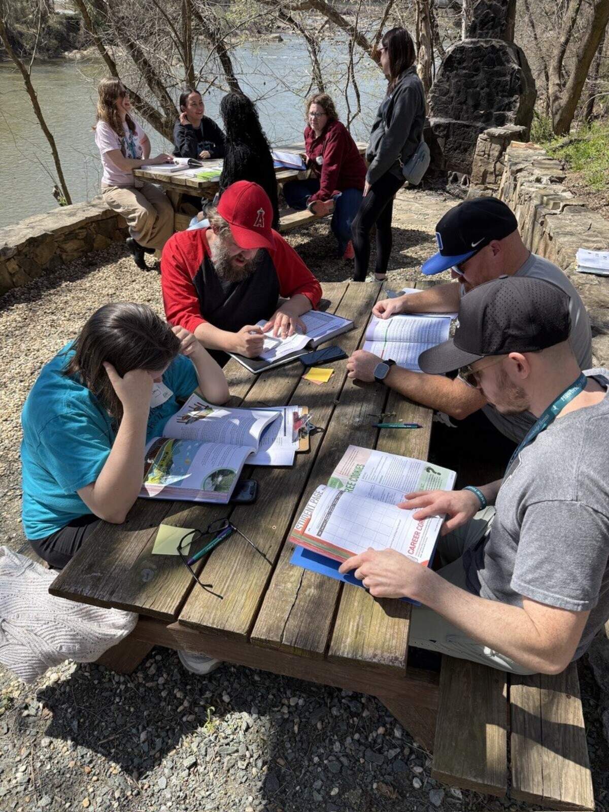 Strnad helps teachers from Hawbridge Elementary School in Saxapahaw to determine what Project Learning Tree activities could be used along the river behind their school to connect children with their local environment. Strnad is a North Carolina certified environmental educator. That program was eliminated from the recently passed state budget.